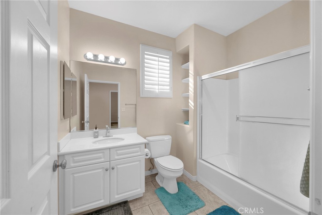 10 Agave Court Ladera Ranch, CA 92694 - Photo 19 of 36 a bathroom with a toilet a sink and a mirror