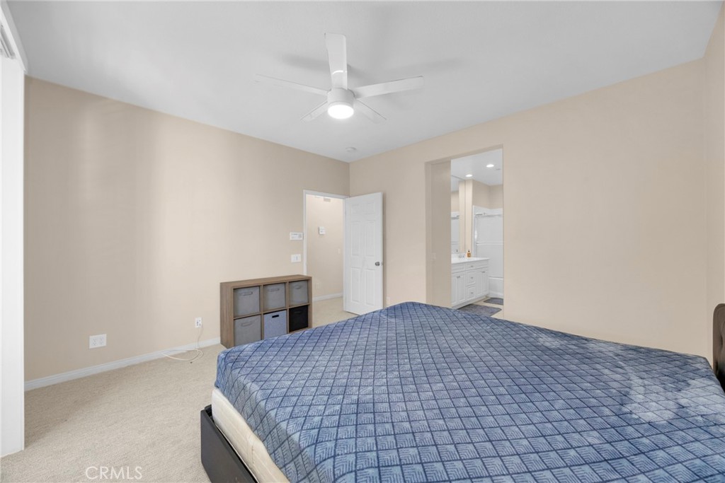 10 Agave Court Ladera Ranch, CA 92694 - Photo 22 of 36 a bedroom with a large bed and a chandelier