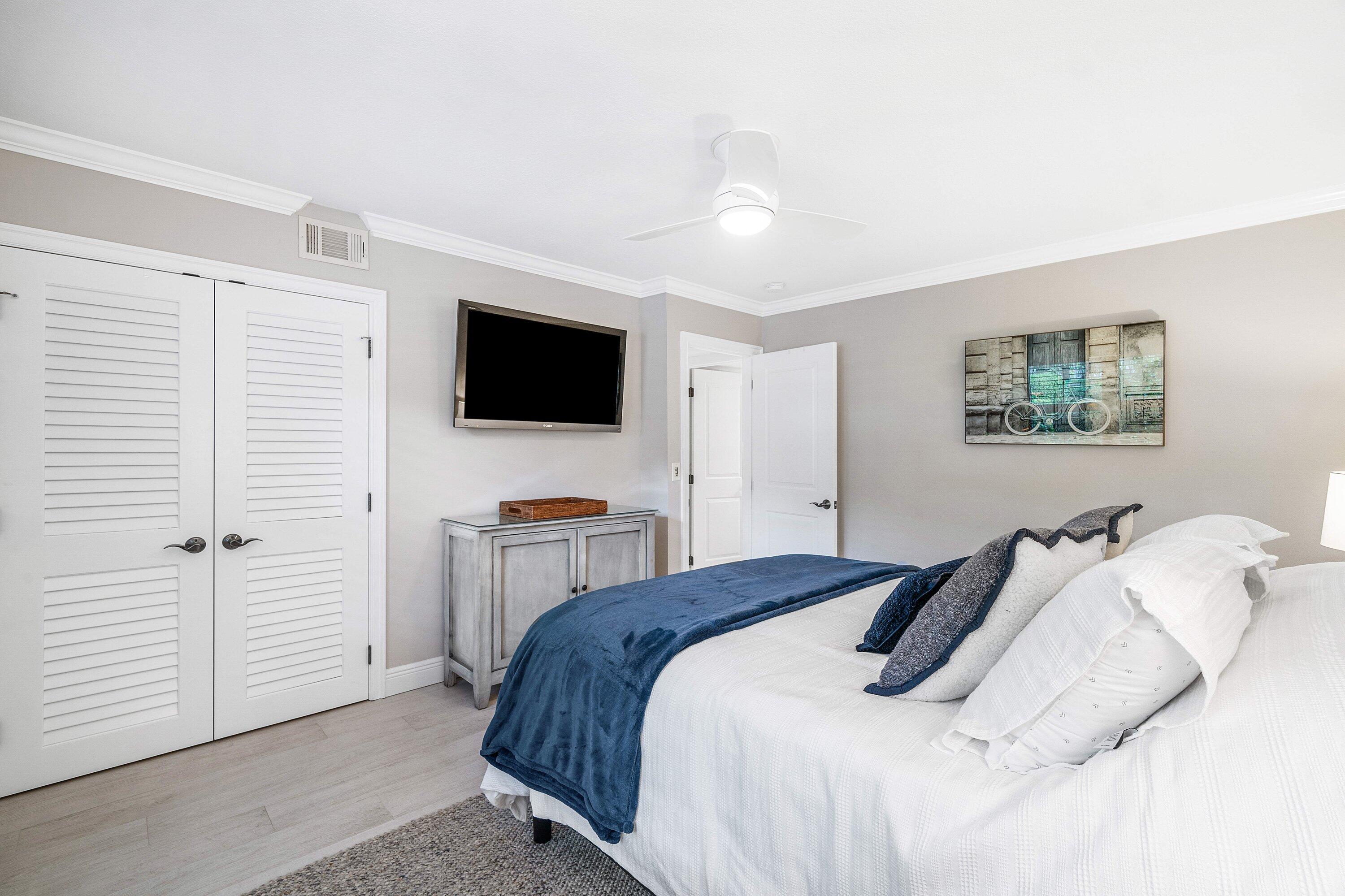 38 Southport Lane, Unit A Boynton Beach, FL 33436 - Photo 15 of 65 a bedroom with a bed and a flat screen tv