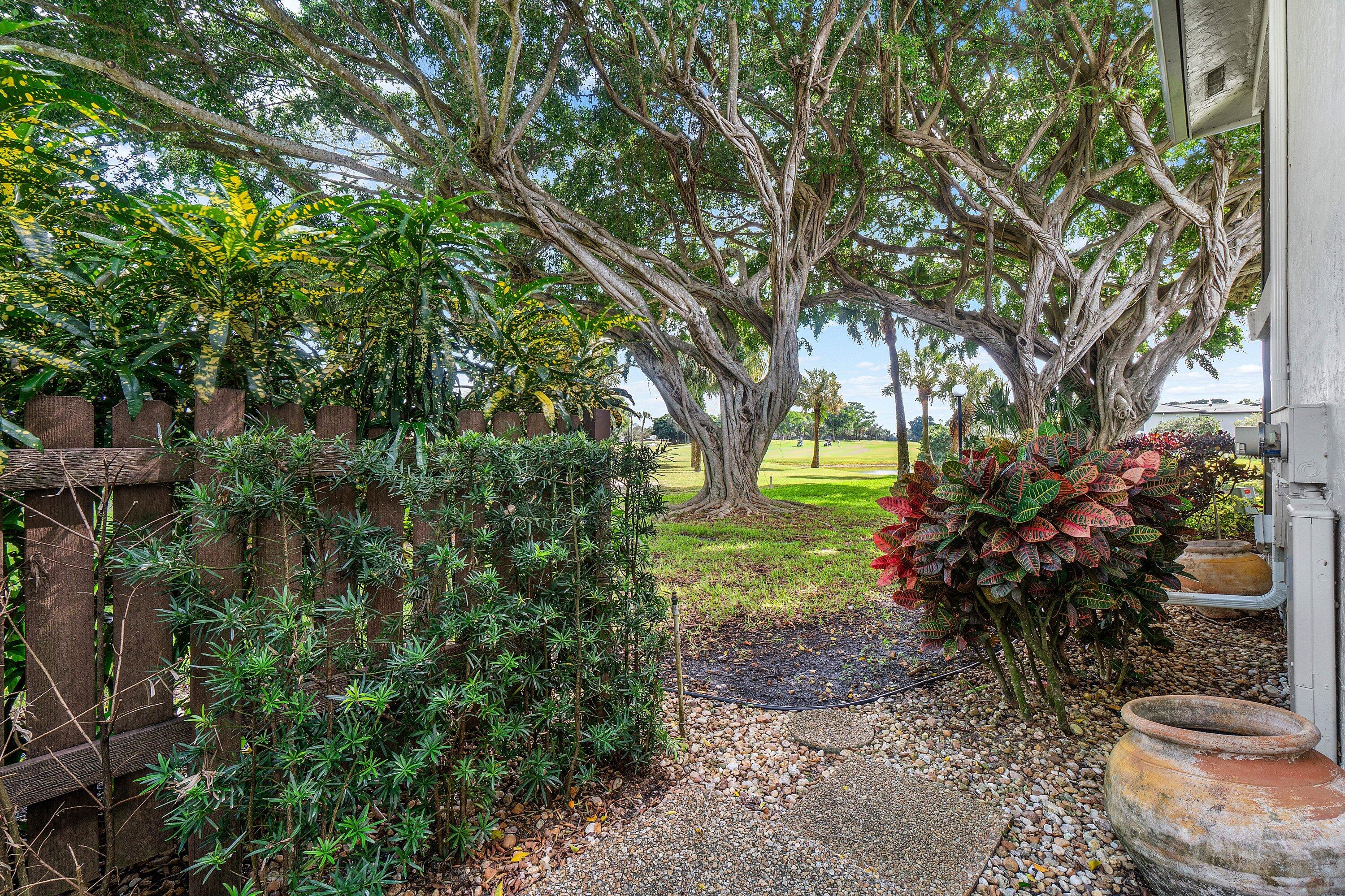 38 Southport Lane, Unit A Boynton Beach, FL 33436 - Photo 27 of 65 a view of a garden with large trees