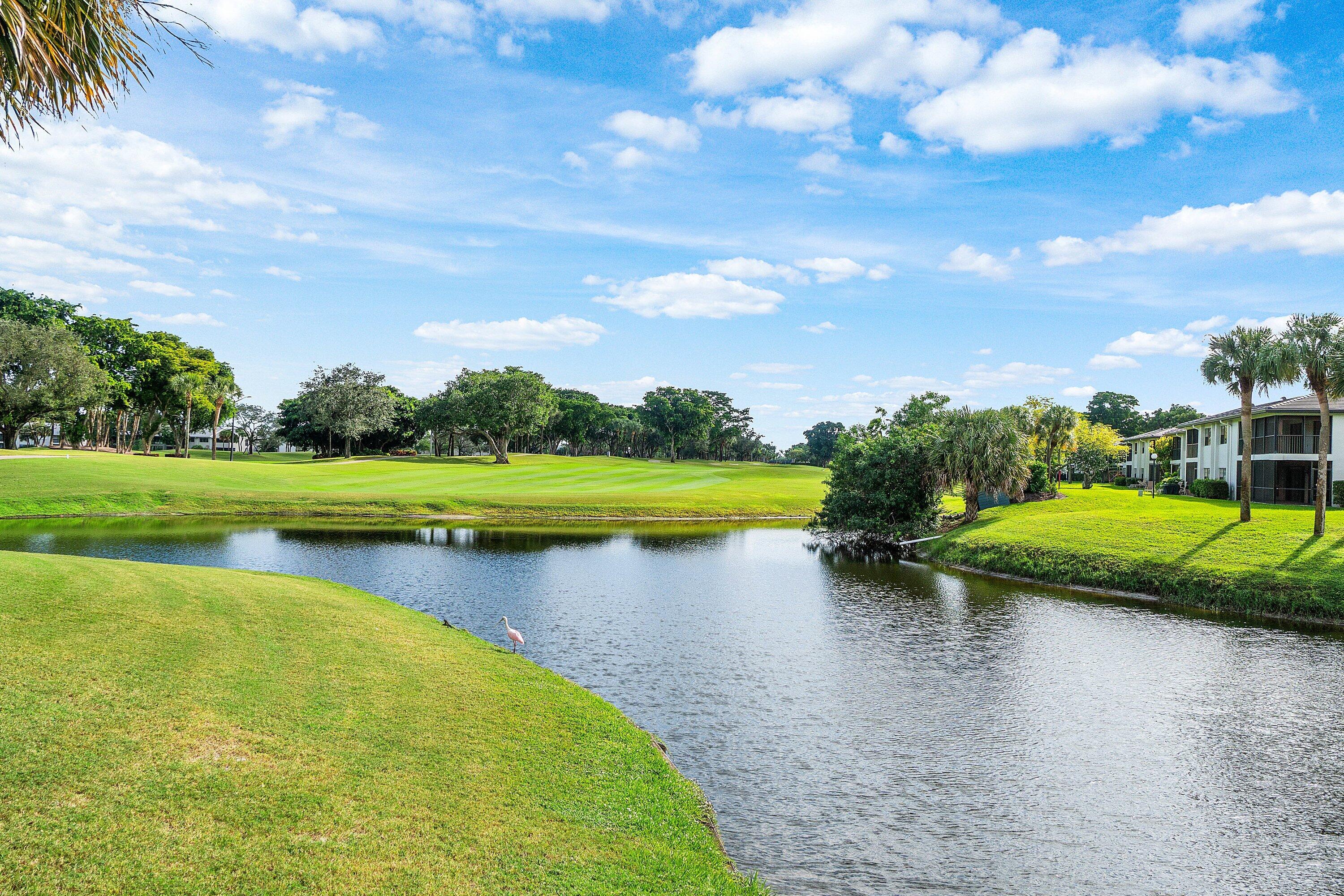 38 Southport Lane, Unit A Boynton Beach, FL 33436 - Photo 33 of 65 a view of a lake with houses in the back