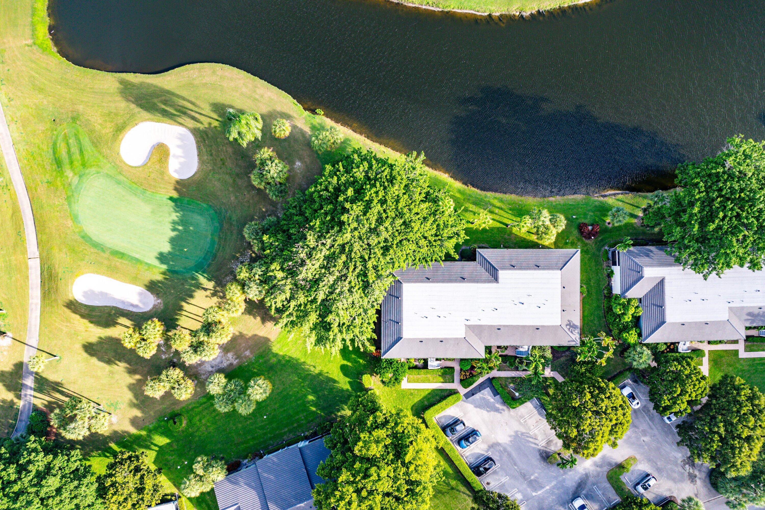 38 Southport Lane, Unit A Boynton Beach, FL 33436 - Photo 38 of 65 an aerial view of a house with a yard and garden