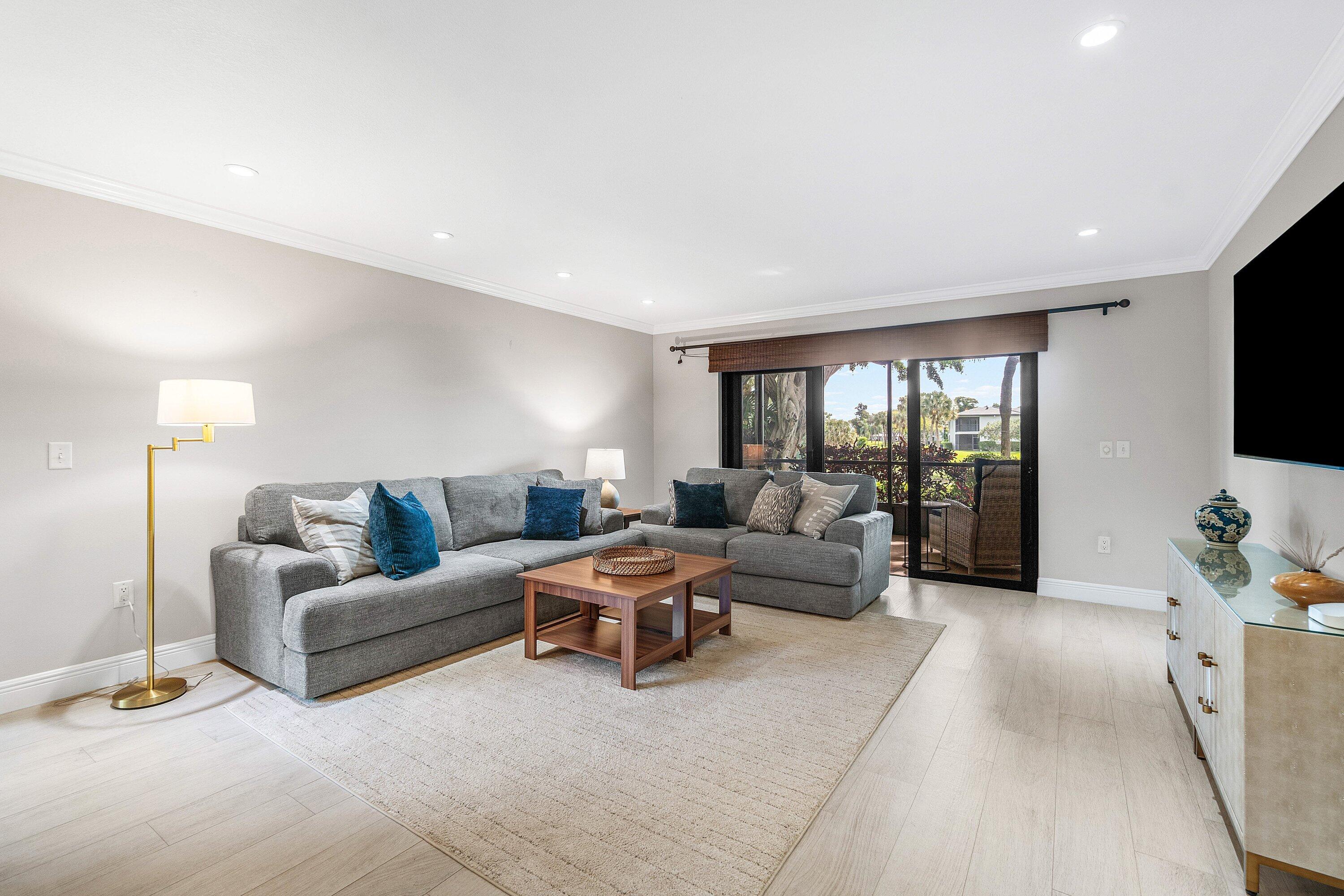 38 Southport Lane, Unit A Boynton Beach, FL 33436 - Photo 6 of 65 a living room with furniture and a flat screen tv
