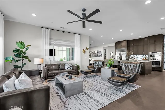a living room with furniture and kitchen view