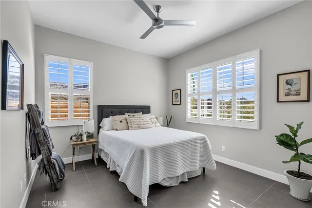 a bedroom with a bed chair and a window