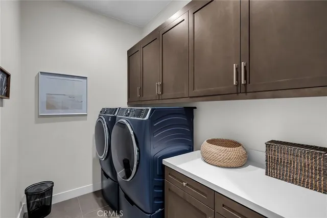 a utility room with sink dryer and washer