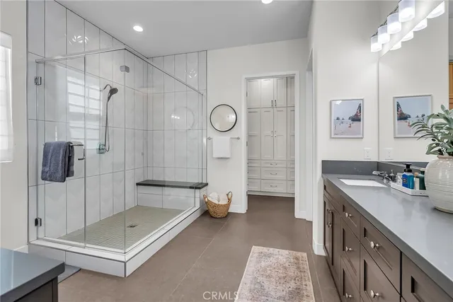 a bathroom with a double vanity sink mirror and shower