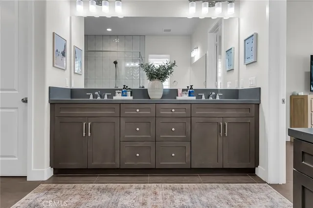 a spacious bathroom with a granite countertop sink and a mirror