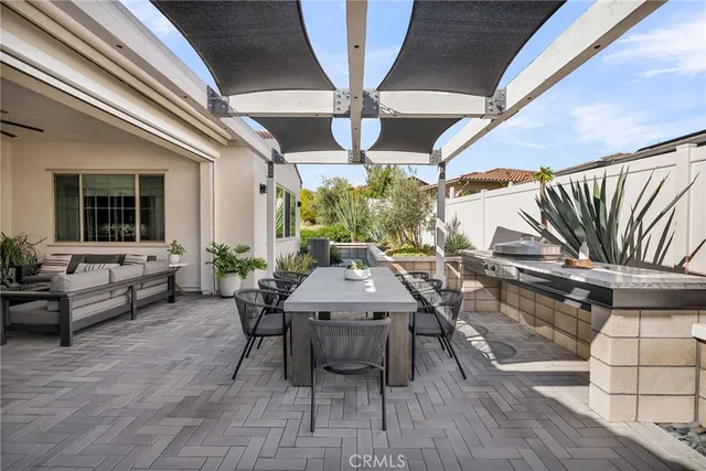 a view of a patio with table and chairs with wooden floor and fence