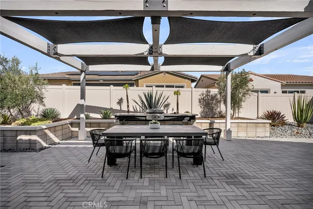 a view of a dinning table and chairs in the patio