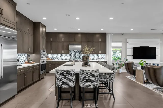 a large kitchen with a table and chairs