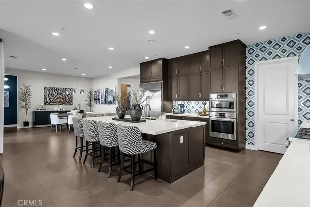 a kitchen with stainless steel appliances kitchen island granite countertop a sink and cabinets