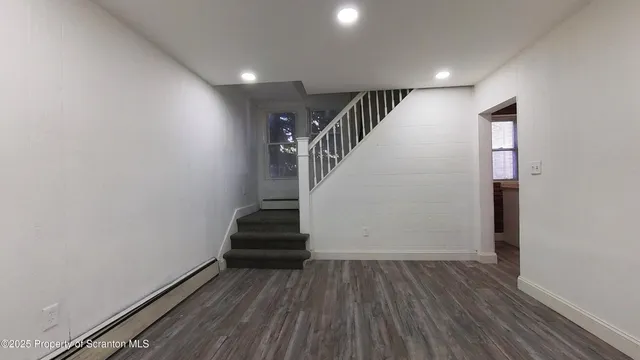 wooden floor in an empty room with stairs