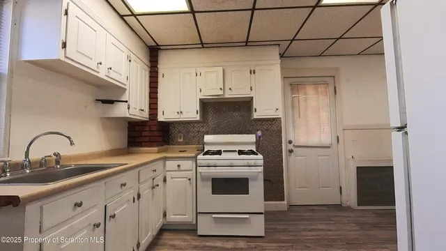 a kitchen with cabinets a sink and a stove