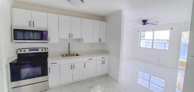 a kitchen with a sink stove and cabinets
