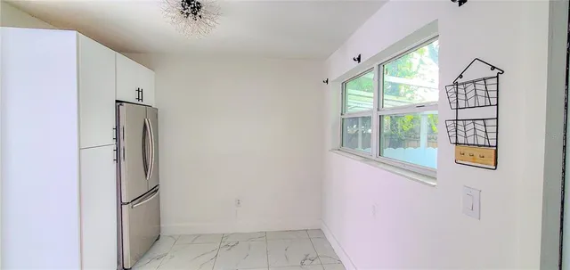 a view of empty room with a fireplace and windows