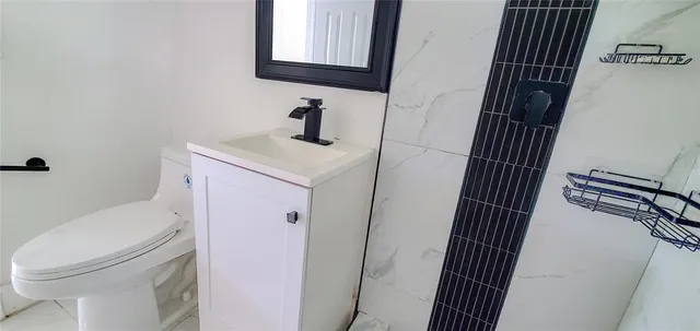 a bathroom with a sink toilet and shower