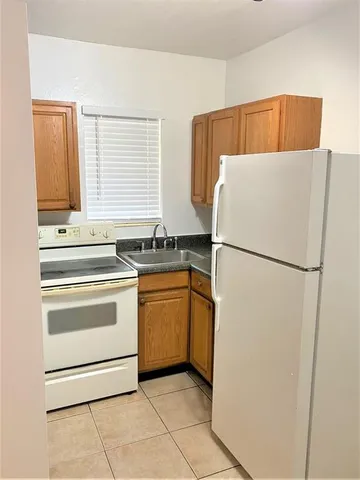 a kitchen with a refrigerator and a stove