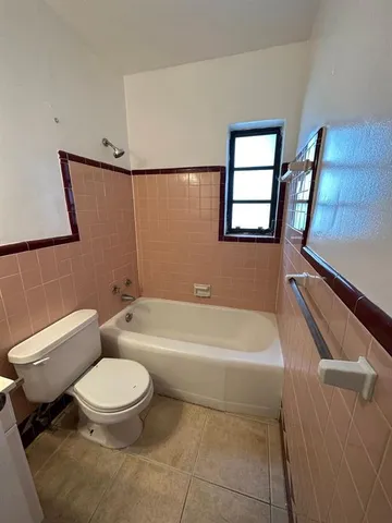 a bathroom with a toilet a sink and bathtub