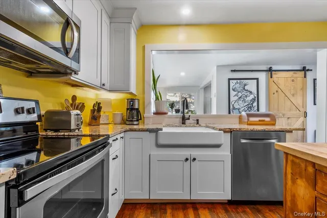 a kitchen with kitchen island a stove and a sink