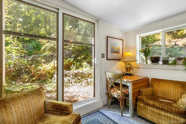 a dining room with furniture and a window