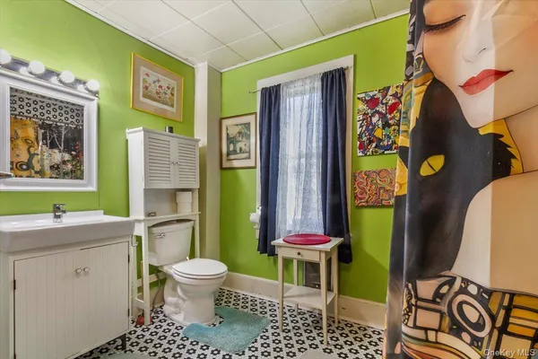 a bathroom with a granite countertop sink a toilet and shower