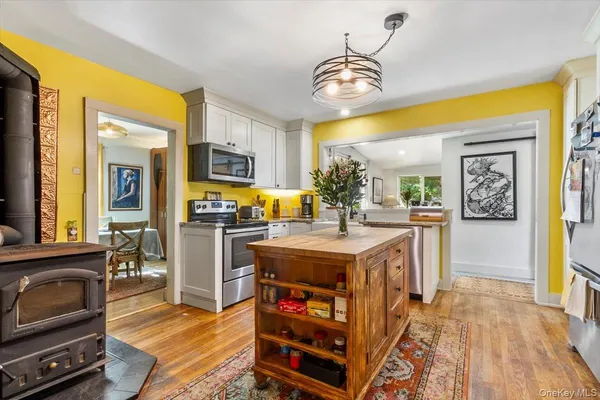 a kitchen with stainless steel appliances a stove a refrigerator and a microwave