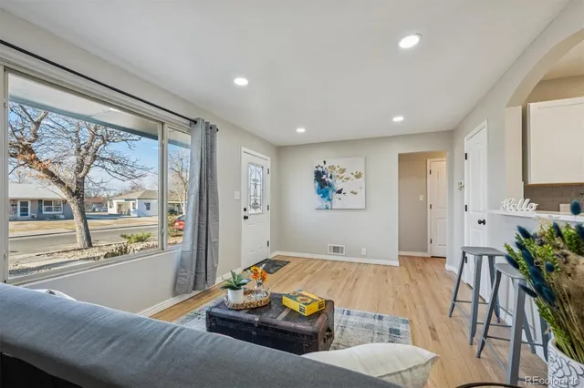 a living room with furniture and a large window