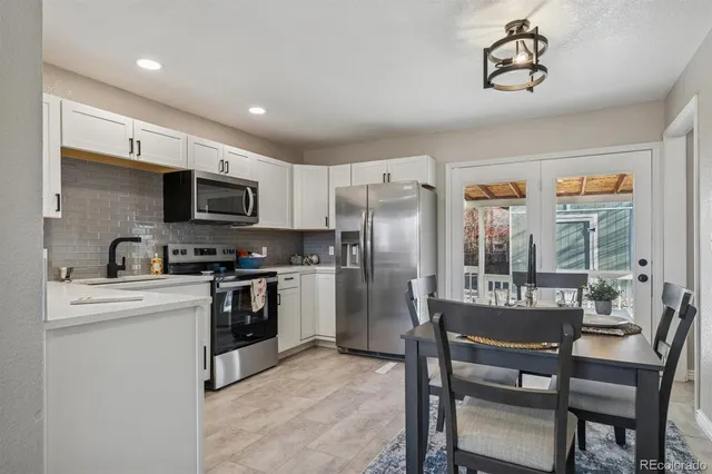 a kitchen with kitchen island a refrigerator stove and microwave