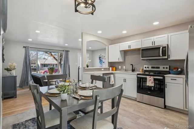 a view of kitchen with microwave stove top oven and cabinets