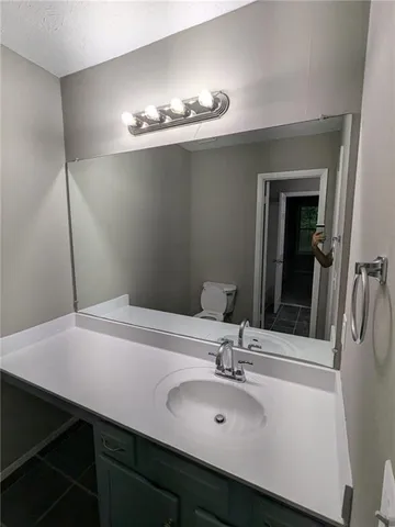 a bathroom with a sink toilet and vanity