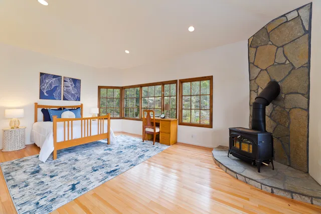 a bedroom with furniture and a wooden floor