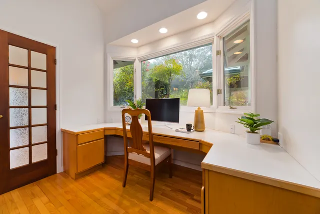 a view of a dining room with furniture window and wooden floor