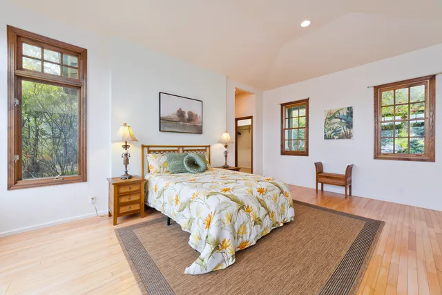 a bedroom with a bed and a table with window