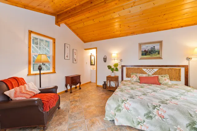 a view of a living room with furniture and wooden floor