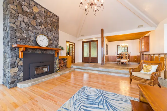 a living room with furniture a clock and a fireplace
