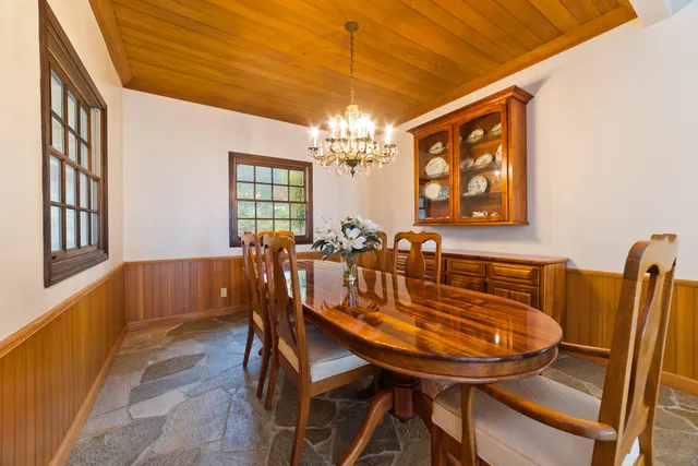 a view of a dining room with furniture and window