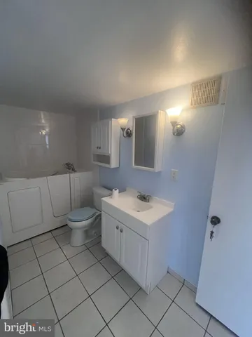 a bathroom with a sink toilet and mirror