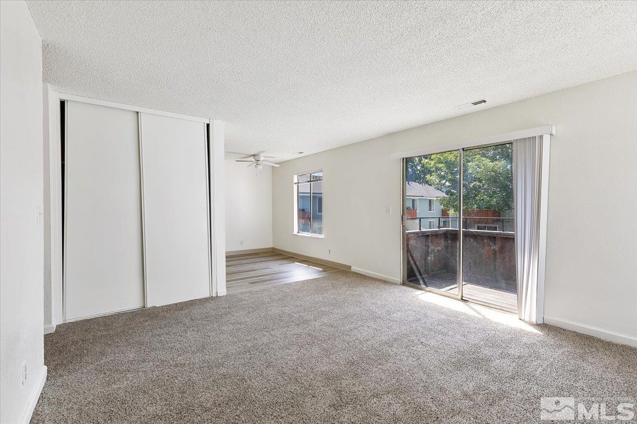 4602 Neil Road, Unit 72 Reno, NV 89502 - Photo 4 of 15 a view of a big room with windows and chandelier fan