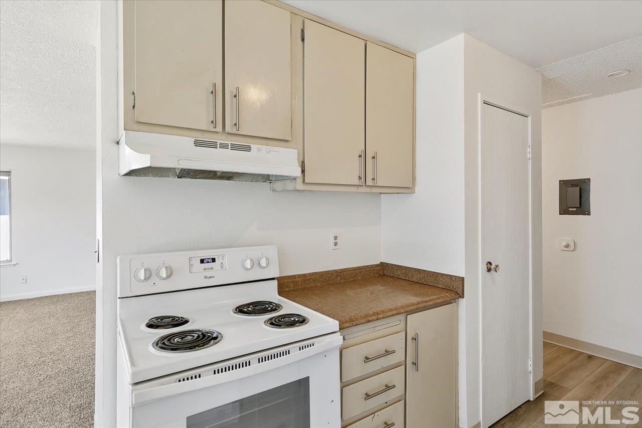4602 Neil Road, Unit 72 Reno, NV 89502 - Photo 8 of 15 a kitchen with white cabinets and white appliances