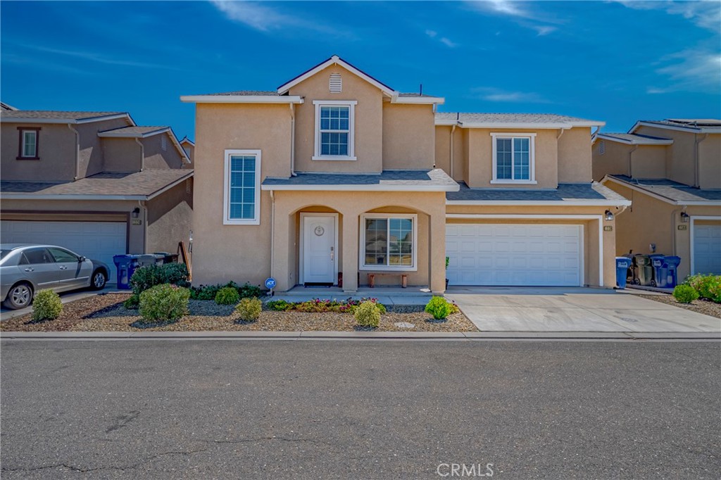 a front view of a house with a yard and a garage