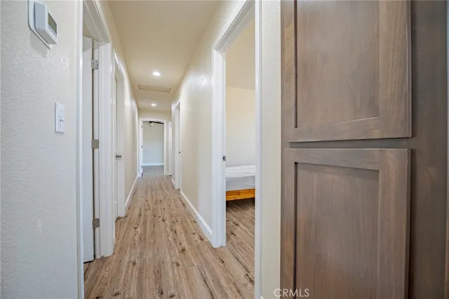 a view of hallway with wooden floor
