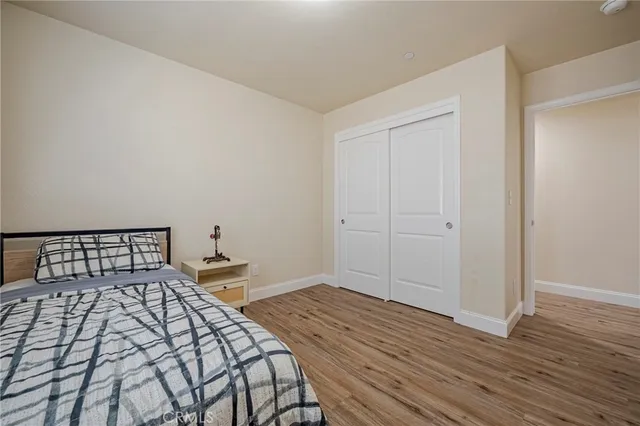 a bedroom with a bed and wooden floor