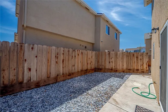 a view of a backyard with wooden fence