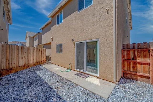 a view of a backyard with wooden fence