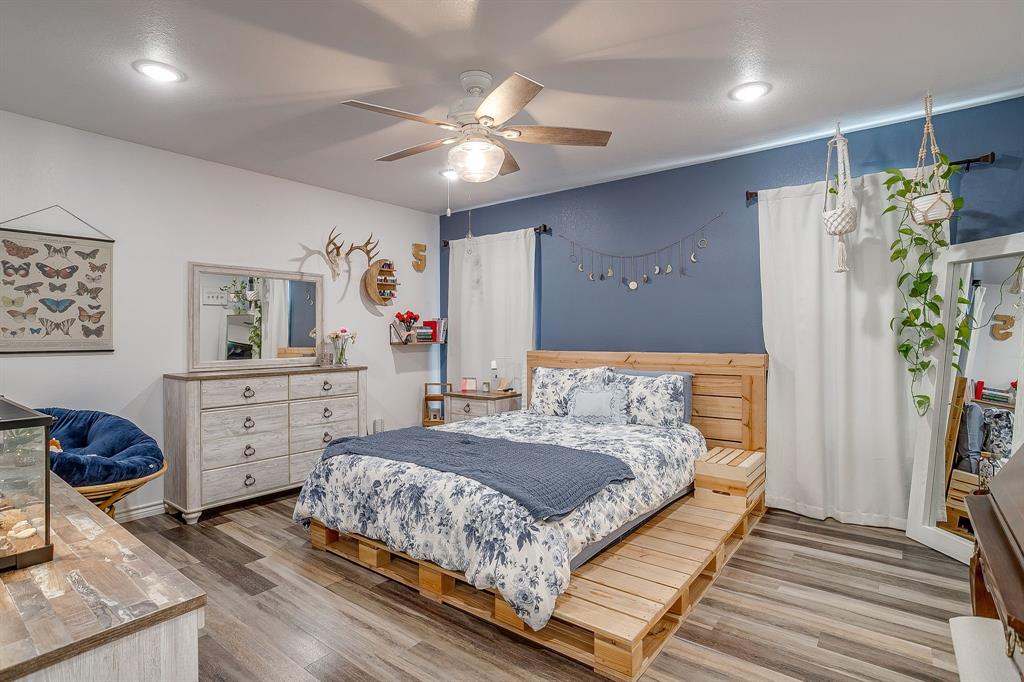 733 Fm 2652 Graham, TX 76450 - Photo 21 of 40 a bedroom with a bed and a chandelier
