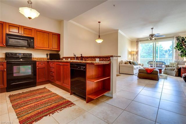 a kitchen with stainless steel appliances granite countertop a stove top oven and cabinets