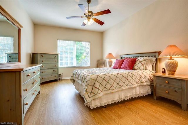 a bedroom with a bed dresser and a window