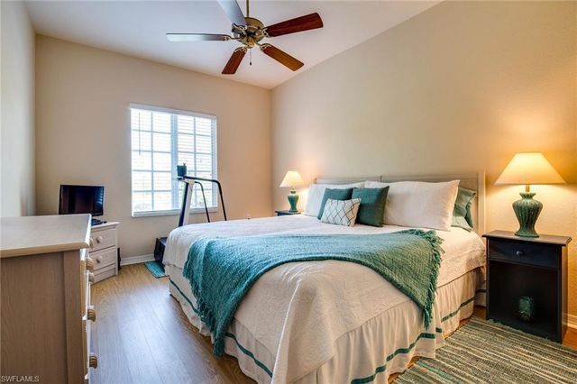 a spacious bedroom with a bed and a window