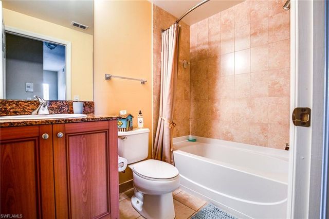 a bathroom with a bathtub toilet sink vanity and shower